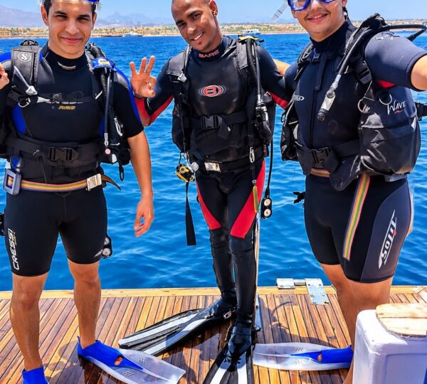 An adventurous trio glowing with enthusiasm, ready to dive into the enchanting depths of the Red Sea and discover the secrets of the underwater world.