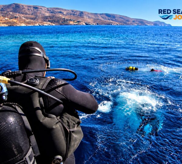 Scuba diver preparing to jump from a boat into the Red Sea for a drift dive
